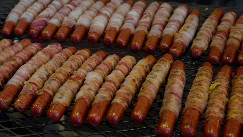 bacon wrapped hot dogs on the grill