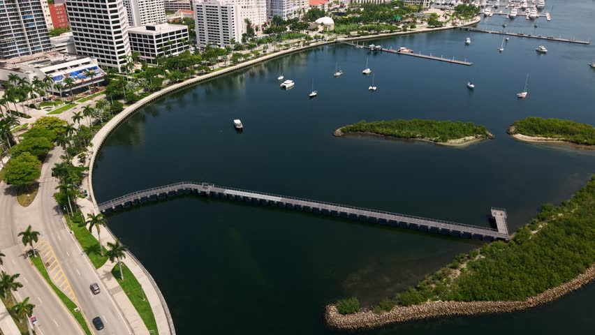 West Palm Beach harbor with boardwalk and mangrove South cove islands from above, aerial dolly to Flagler drive docks