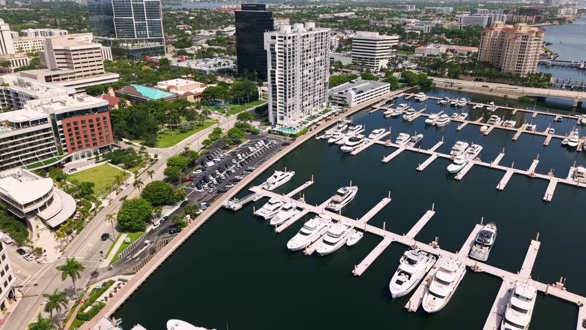 West Palm Beach marina filled with luxury yachts beside downtown along Flagler Drive, aerial