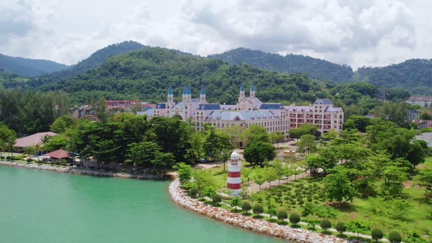 Smooth drone orbit showcasing a charming waterfront lighthouse along Langkawi