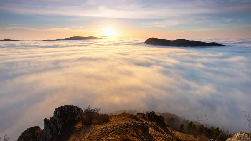 Time lapse of Colorfull sunset behind Mountain peak landscape above clouds - panorama