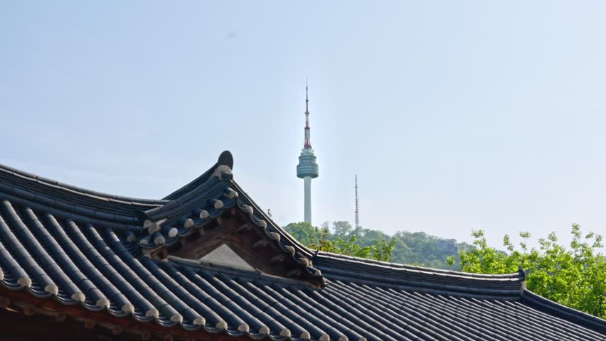 N Seoul Tower is a 238-meter communication and observation tower atop Namsan Mountain, offering iconic panoramic city views, romantic love locks, and colorful night light displays.
