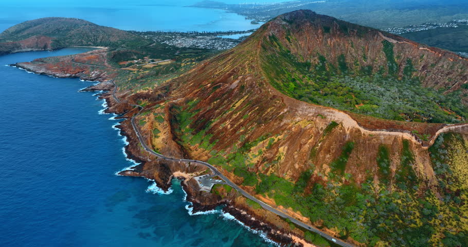 Footage over the highway on the slope of the picturesque rocks. Koko Head Crater from above the Pacific Ocean waterscape.