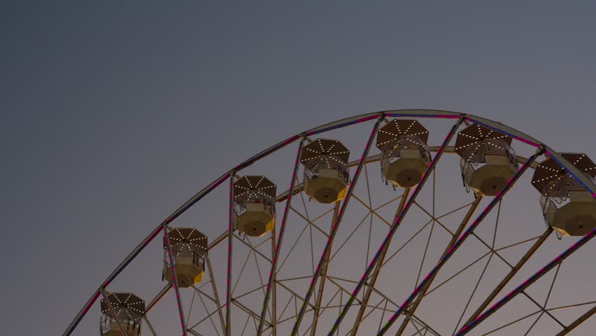 wide shot of ferris wheel ride going around at the fair