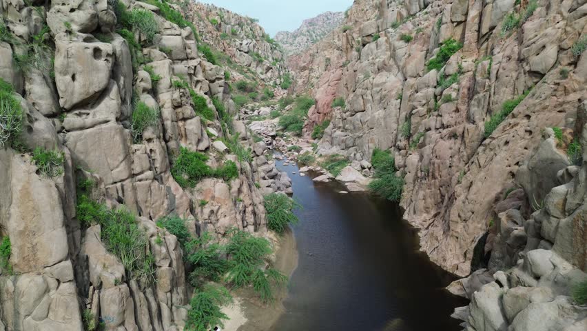 Natural stream flowing through a rugged mountain landscape