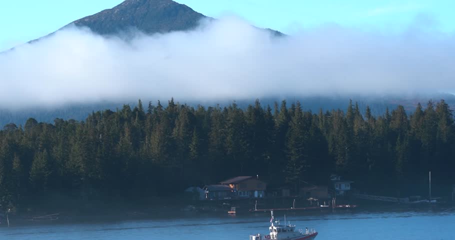 Ketchikan, Alaska forest landscape with fast moving clouds and boat, close up