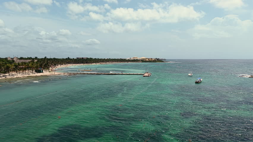 Aerial view of Caribbean sea ,sandy beach, pier with docked boats and palm trees in Playa del Carmen, Cancun, Mexico