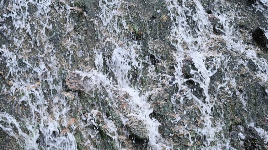 Close-up view of flowing waterfall over rugged rocks