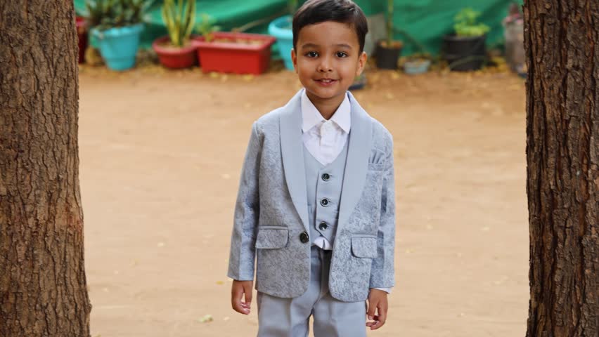 Stylish Young Boy in Elegant Suit Standing Outdoors for Special Celebration Portrait