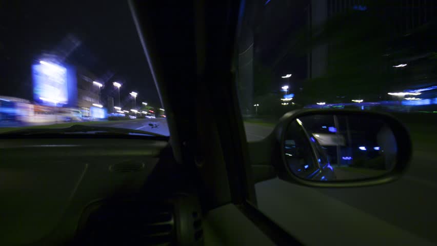 Car driving by night Rush hour look throu rearview mirror Time lapse