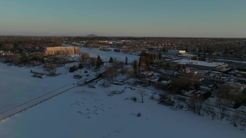 drone flying around the chambly channel a historic site of canada in winter exposing the site n the coastline of the river richelieau