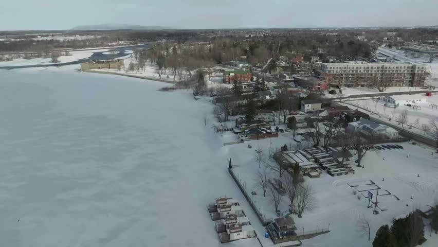 drone going from chambly channel all the way to castle fort chambly in quebec canada in winter over the coastline
