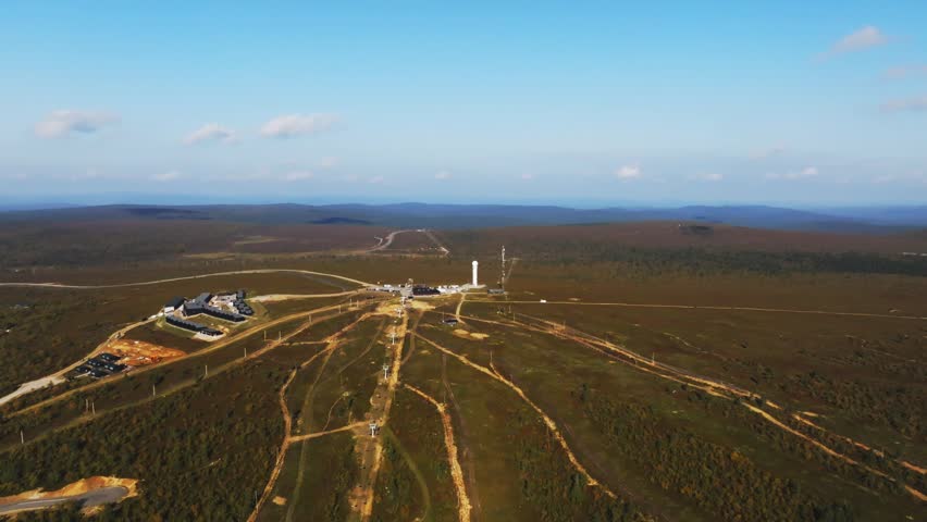 Aerial view of Urho Kekkonen National Park with ski slopes and buildings in the vast landscape of Saariselka, Lappi, Finland.
