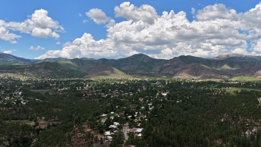 Aerial view of cloud shadows moving over mountains above the town of Los Alamos, NM, United States.