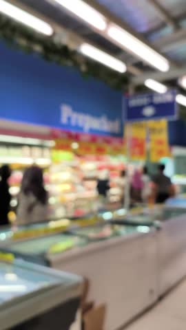 Blurred supermarket milk and fruits area, 4K background bokeh video, vertical video