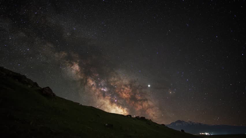 Night landscape, mountains under bright colorful milky way galaxy. Space, night scene time lapse.