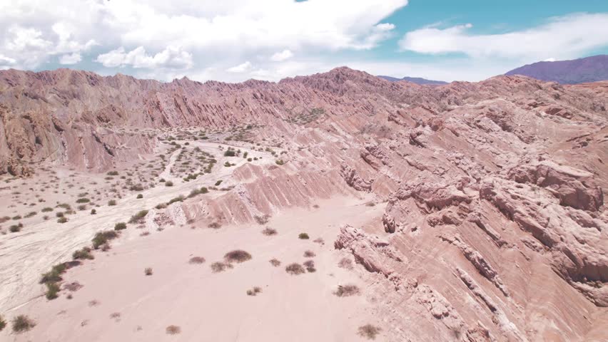 4K drone aerial view of Santa Rosa, Salta, Argentina. Unique white rock formations with geometric shapes and dramatic Andean landscapes shaped by natural erosion.