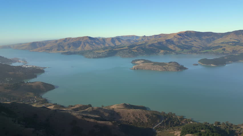 Scenic Diamond Harbor Canterbury New Zealand Ocean Wraps Around Mountains Drone Track Back High Angle 4K 60FPS