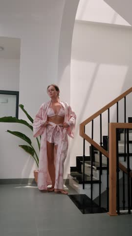Woman wearing coordinated kimono robe with matching bralette and lounge shorts.
