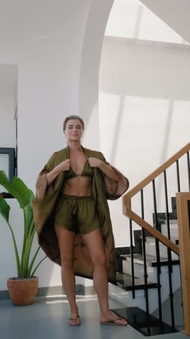 Woman wearing coordinated kimono robe with matching bralette and lounge shorts.