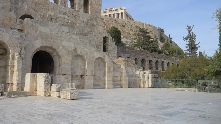 Arched stone facade of Odeon of Herodes Atticus below the Acropolis in Athens Greece