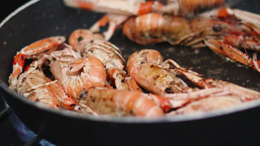 Fresh Langoustines Being Turned While Cooking in Hot Pan. Shellfish Seafood being Cooked Outdoors in Slow Motion. Norway Lobster.