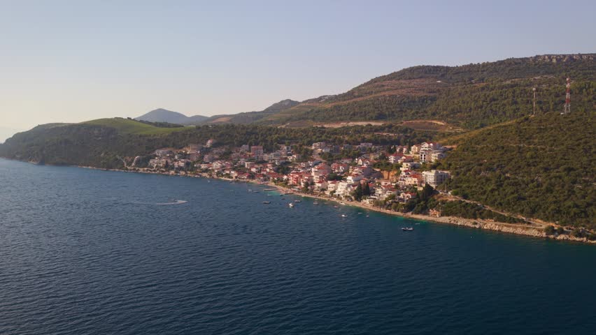 Aerial landscape view of the coastal village of Komarna along the Adriatic shoreline near Peljesac Bridge in Croatia