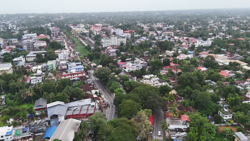 A spectacular aerial panorama of Alappuzha highlighting urban development, vibrant neighborhoods, canal roads, and lush coconut landscapes. Ideal stock footage for tourism and promotional storytelling