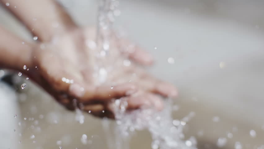 The hands of a child from a poor community are outstretched to receive a flowing stream of clear, fresh water. | Shutterstock HD Video #4150639