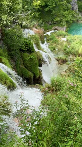 Slow Motion Waterfall Flowing Into Turquoise Lake at Plitvice Lakes National Park, Croatia