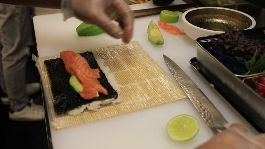 The chef prepares sushi dishes
