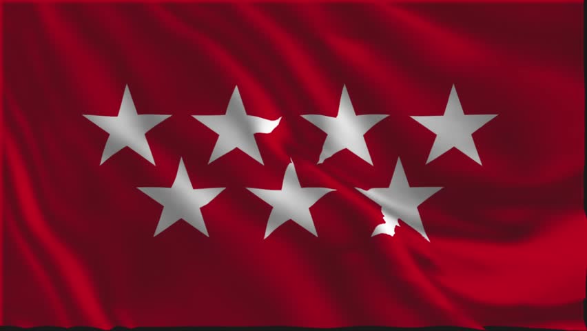 Flag of Madrid waving slowly in the foreground