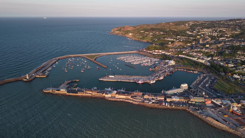 High aerial of Howth town and harbour overlooking Dublin Bay, Ireland. Wide panorama