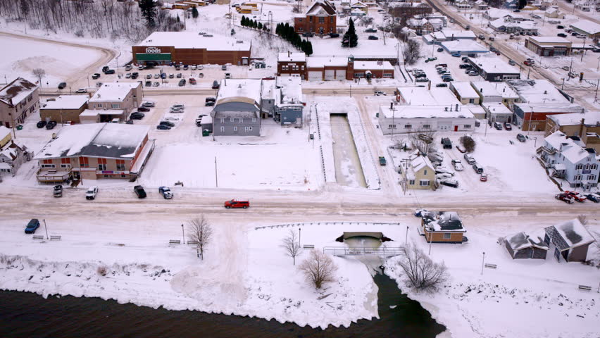 Aerial drone shot soaring above Huron Bay with the town of L