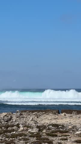 Powerful Turquoise Ocean Waves Crashing on a Rocky Coral Coastline in Melasti Beach Bali