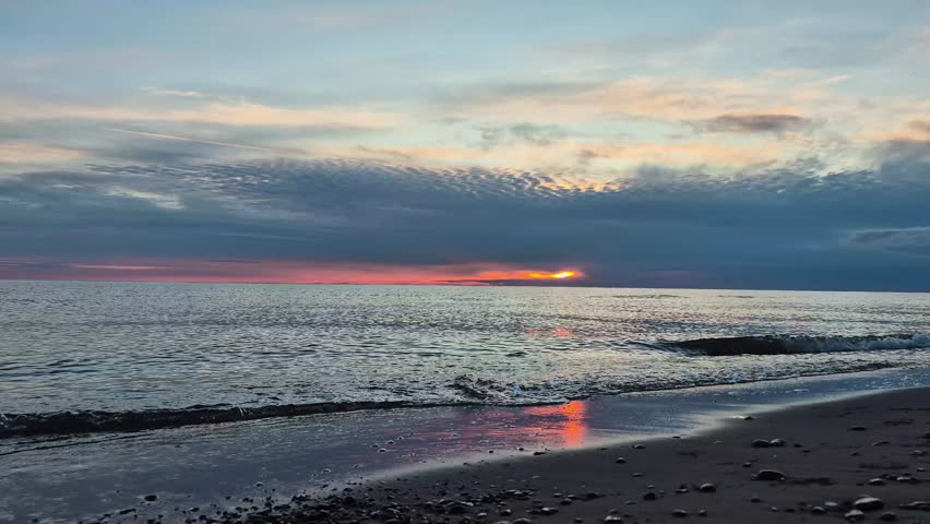 Beautiful Sunset Over The Baltic Sea In Latvia. Golden Sunlight Reflects On Calm Waves, Creating A Peaceful Coastal Landscape With Colorful Sky, Natural Beauty And Relaxing Summer Evening Atmosphere
