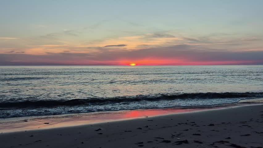 Beautiful Sunset Over The Baltic Sea In Latvia. Golden Sunlight Reflects On Calm Waves, Creating A Peaceful Coastal Landscape With Colorful Sky, Natural Beauty And Relaxing Summer Evening Atmosphere