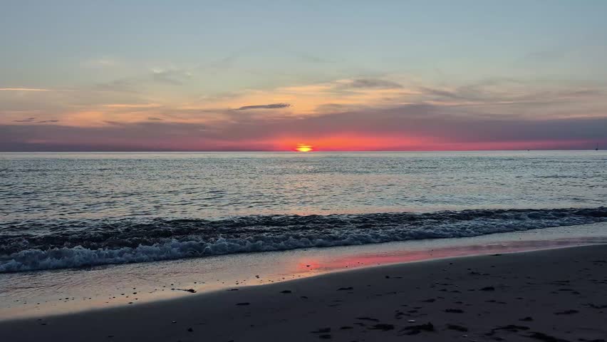 Beautiful Sunset Over The Baltic Sea In Latvia. Golden Sunlight Reflects On Calm Waves, Creating A Peaceful Coastal Landscape With Colorful Sky, Natural Beauty And Relaxing Summer Evening Atmosphere