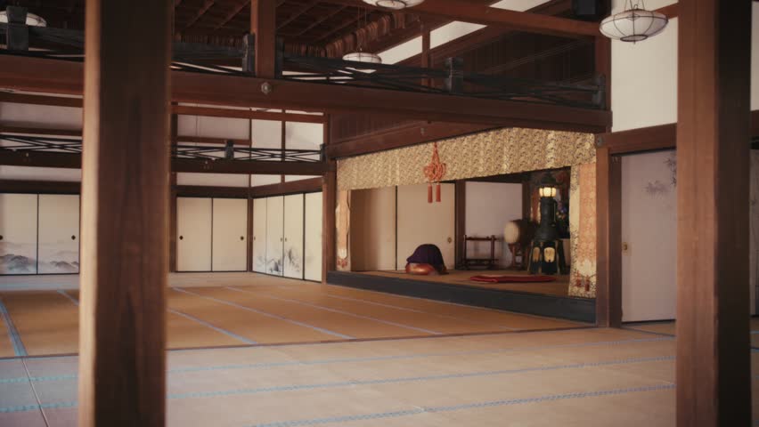 The interior of a traditional hall at Kencho-ji temple in Kamakura, showcasing tatami flooring, wooden pillars, sliding fusuma doors, and a raised altar space visible through an ornate curtain.