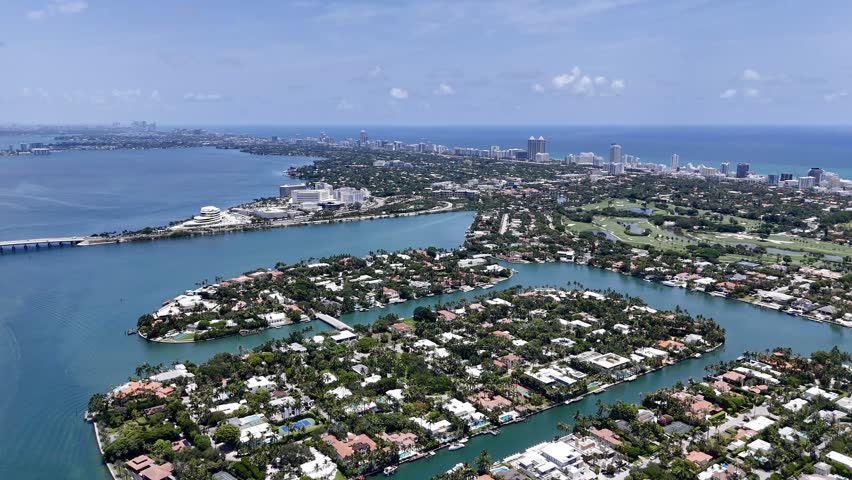 Aerial view of Miami skyline and waterfront islands over turquoise Biscayne Bay in sunny Florida, USA. g.