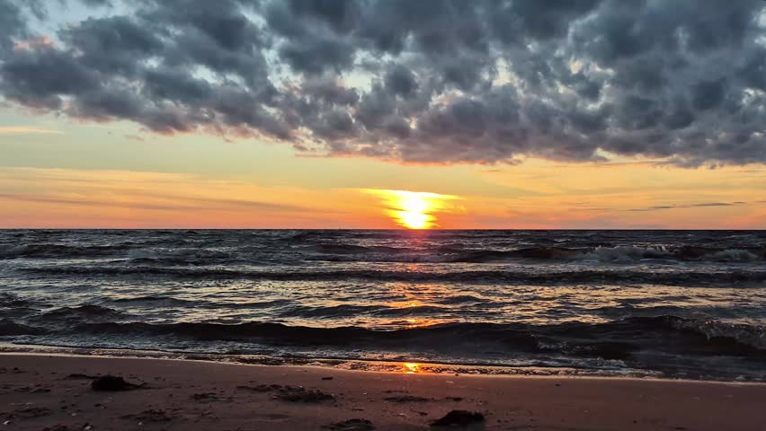 Beautiful Sunset Over The Baltic Sea In Latvia. Golden Sunlight Reflects On Calm Waves, Creating A Peaceful Coastal Landscape With Colorful Sky, Natural Beauty And Relaxing Summer Evening Atmosphere