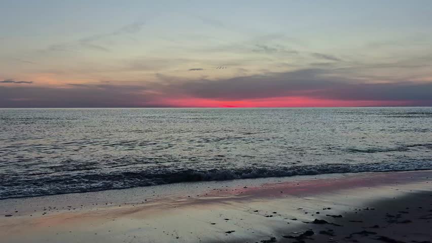 Beautiful Sunset Over The Baltic Sea In Latvia. Golden Sunlight Reflects On Calm Waves, Creating A Peaceful Coastal Landscape With Colorful Sky, Natural Beauty And Relaxing Summer Evening Atmosphere