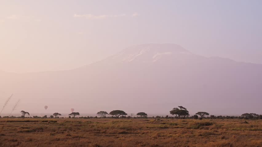 Hot Air Balloon Safari in Africa with Mount Kilimanjaro Summit from Amboseli National Park in Kenya. Hot Air Balloon Tour on Luxury Safari in Beautiful Landscape Scenery over the Plains and Savannah.