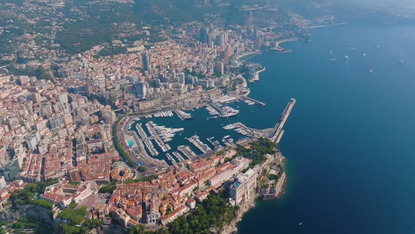 Stunning aerial perspective showing the densely populated cityscape of Monaco, including the old town and the famous Port Hercules filled with yachts