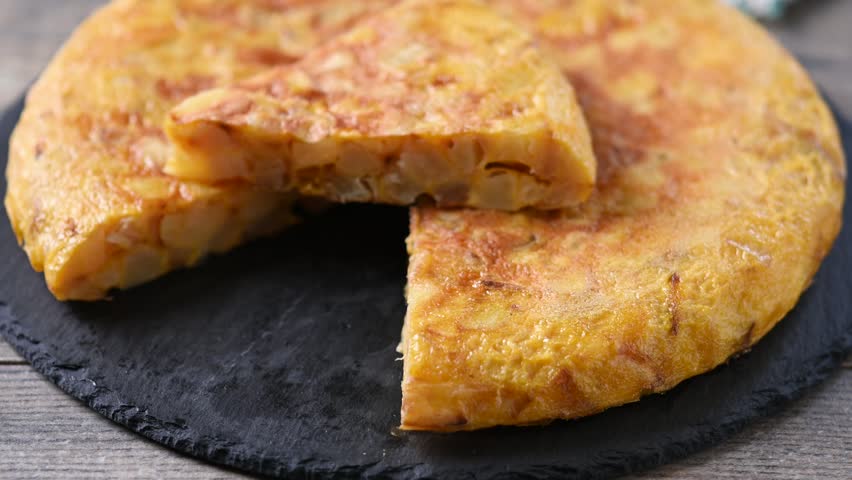 Spanish potato omelette on wooden table