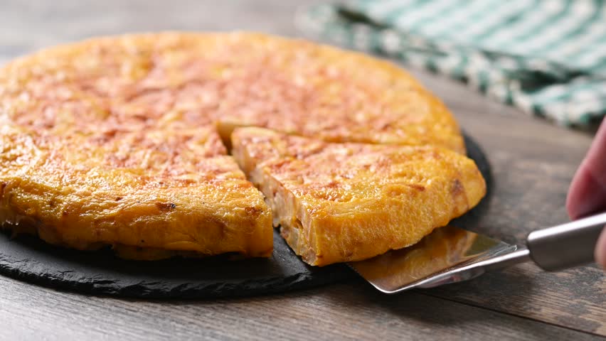 Taking a slice of Spanish potato omelette