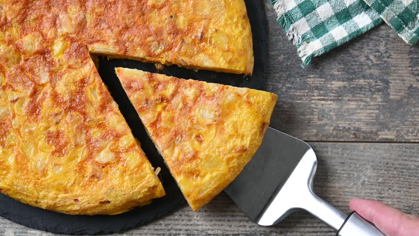 Taking a slice of Spanish potato omelette