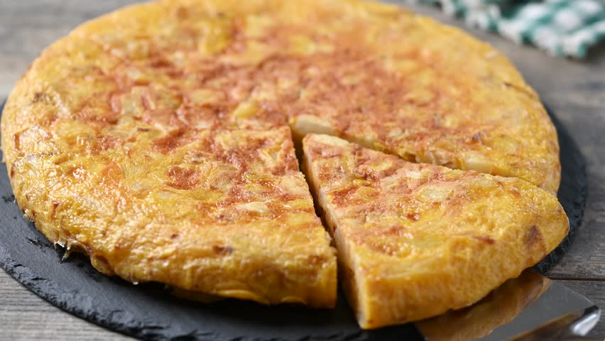 Taking a slice of Spanish potato omelette