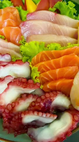 Premium Japanese sashimi platter featuring fresh salmon, otoro, salmon belly, sweet shrimp, squid, octopus, and surf clam served on ice
