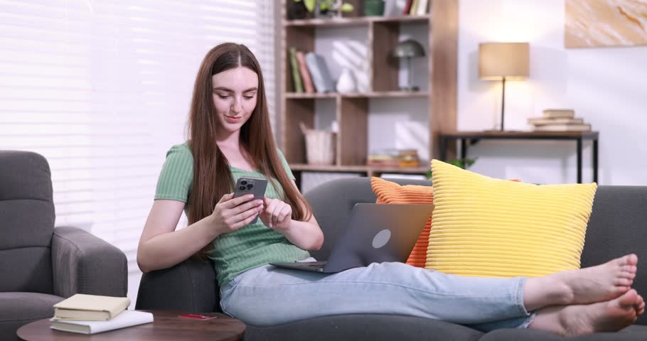 Online store shopping. Woman using smartphone and laptop at home. Camera moving